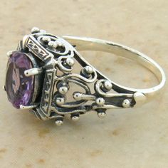 Vintage Silver Amethyst Ring Birthstone, Vintage Stamped 925 Amethyst Ring, Ornate Amethyst Anniversary Rings, Vintage Amethyst Sterling Silver Ring, Heirloom Sterling Silver Amethyst Ring, Antique Amethyst Ring Stamped 925 For Anniversary, Ornate Purple Anniversary Rings, Ornate Purple Ring For Anniversary, Sterling Silver Amethyst Promise Ring With Intricate Design