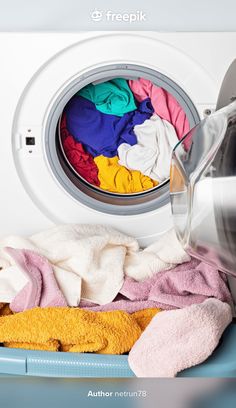 the washing machine is filled with colorful clothes