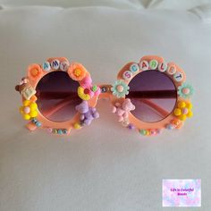 Children's Custom Sunglasses made to order. Choose your charms, colors, letters, sunglasses style, etc. Custom Name Pink Sunglasses With Adjustable Fit, Pink Sunglasses With Custom Name And Adjustable Fit, Fun Handmade Sunglasses As A Gift, Handmade Fun Pink Sunglasses, Pink Personalized Adjustable Sunglasses, Fun Handmade Pink Sunglasses, Fun Pink Handmade Sunglasses, Retro Sunglasses With Tinted Lenses As Gift, Retro Sunglasses With Tinted Lenses For Gift