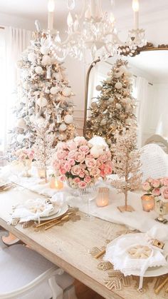 a dining room table decorated for christmas with pink and white flowers on the centerpiece