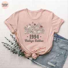 a t - shirt that says 1994 with flowers on it and the words, vintage edition