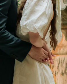 the bride and groom are standing close together