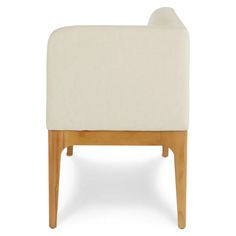 an upholstered chair with wooden legs and a white fabric seat pad on the back