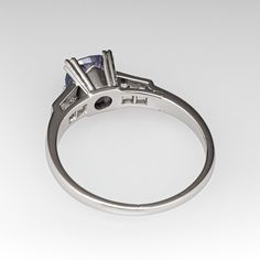 This alluring ring is centered with a no heat Tanzanian sapphire weighing 1.75 carats that we sourced and set in an elegant vintage platinum mounting. The shoulders of the ring are each accented with two (2), bead set, old European/single cut diamonds. The ring measures 7.0mm at the top, rises 7.2mm above the finger, tapering to 1.6mm wide and 1.2mm thick at the base of the shank. This ring is currently a size 9.75. Classic Formal Diamond Ring With Lab-created Sapphire, Timeless Sapphire Ring In Platinum With Vvs Clarity, Vvs Clarity Asscher Cut Sapphire Ring In Platinum, Asscher Cut Sapphire Ring In Platinum With Vvs Clarity, Classic Platinum Sapphire Ring With Center Stone, Formal Platinum Sapphire Ring With Vvs Clarity, Classic Brilliant Cut Sapphire Platinum Ring, Classic White Gold Sapphire Ring Princess Cut, Brilliant Cut Tanzanite Diamond Ring In White Gold