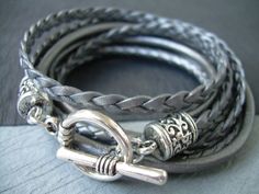 Style# TSB02TW - Get your metallic Gray/Silver on just in time for the Holidays! ... Super stylish and feminine. Wrap it three times around your wrist, toggle up and off you go. This Triple Wrap Leather Bracelet features 3mm round, 3mm braided and 5mm flat braided metallic leather cords. Lead and Nickel Free - Aged Silver Toned Alloy Components, Secure Toggle Closure for Easy on and off. All dyes used in our leather are certified 100% Lead-Free and meet all requirements of the German Goods Ordin Handmade Silver Leather Friendship Bracelet, Adjustable Silver Leather Bracelet With Lobster Clasp, Everyday Silver Leather Bracelet Nickel Free, Silver Leather Bracelet With Lobster Clasp For Everyday, Everyday Silver Leather Bracelet With Lobster Clasp, Elegant Silver Leather Friendship Bracelet, Bracelets Braided, Mens Leather Necklace, Hammered Silver Jewelry