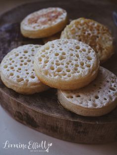 some cookies are sitting on a wooden plate