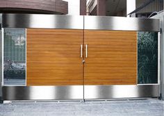 a large metal and wood garage door on the side of a building