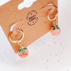 Handmade dainty dangle earrings with beautiful glass peach charms. Made with gold plated stainless steel French hooks. Please note:  In order to maintain the colours of these earrings, avoid wearing them in water.  Possible choking hazard. Not intended for small children. ** All of our items are ready to ship and are sent out via letter mail either ON the day of ordering or the very next day. Gift Orange Hoop Earrings With Ear Wire, Orange Metal Earrings As A Gift, Orange Hoop Earrings With Ear Wire As Gift, Orange Metal Earrings As Gift, Apricot Drop Earrings For Gifts, Orange Hoop Earrings With Ear Wire For Gift, Cute Orange Dangle Jewelry, Trendy Orange Dangle Earrings, Cute Orange Drop Earrings