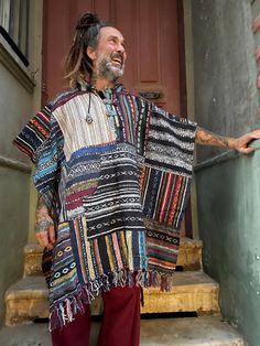 Wrap yourself in vibrant colors and bohemian style with this handmade Nepal Boho Patchwork Poncho. Crafted from 100% Gheri cotton, each poncho is individually hand-stitched, making every piece as unique as you are. The colorful patchwork design showcases traditional Nepalese craftsmanship, offering a one-of-a-kind look. With a roomy hood, wooden toggle buttons, and a front kangaroo pocket, this poncho is perfect for festivals, outdoor adventures, or simply cozying up at home. Designed for comfort and versatility, it's your go-to piece for year-round warmth and style. 📌Features: Material: 100% Handwoven Gheri Cotton Design: Colorful patchwork, each piece is unique Fit: One size, relaxed and roomy Hood: Adjustable hood with drawstrings Details: Wooden toggle buttons, large front pocket Sust Bohemian Woven Poncho For Fall, Fall Bohemian Woven Poncho, Bohemian Handwoven One-size Cape, Bohemian One-size Handwoven Cape, Bohemian Multicolor Poncho For Fall, Bohemian Woven Winter Shawl, Folk Style Festival Poncho One Size, Multicolor Bohemian Poncho For Fall, Casual Multicolor Poncho For Vacation