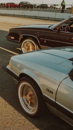 two cars parked next to each other in a parking lot