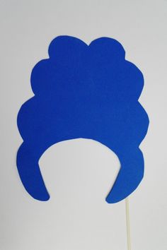 a blue hat shaped like a woman's head on top of a wooden stick