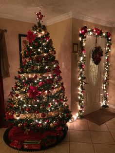 a decorated christmas tree in a living room with lights on the trees and decorations around it