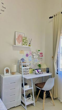 a white desk and chair in a small room