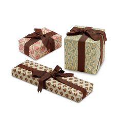 three wrapped gift boxes with brown ribbons and bows on them, all decorated in different patterns