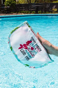 someone is holding up a towel in the pool