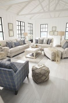 a living room filled with furniture and windows