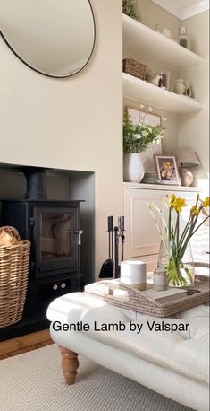 a living room filled with furniture and a fire place next to a wall mounted oven