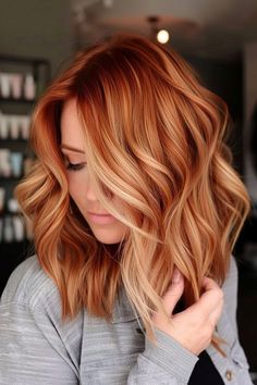 Blonde red hair is a timeless and chic choice! Check out our collection of beautiful red/blonde color ideas, including the copper blonde balayage style you see here. Click for 35+ more styles and follow us for more hair color inspo! Strawberry Blonde Hair With Burgundy Highlights, Red Hair To Blonde Balayage, Lived In Auburn Balayage, Copper Lob With Fringe, Copper And Ash Blonde Hair, Red To Copper Balayage, Red Hair Color Blonde Highlights, Red Base With Blonde Highlights