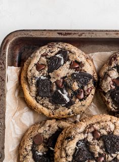 chocolate chip cookies with oreo chips on top in a baking tin, ready to be eaten