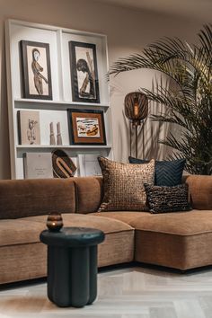 a living room filled with furniture and pictures on the wall