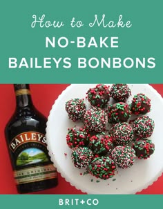 a plate with chocolate covered donuts on it next to a bottle of bailey's