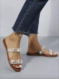 These elegant Clear Strap Flat Sandals are adorned with delicate imitation pearls, adding a touch of sophistication to any outfit. The clear straps provide a modern and sleek look, while the flat design offers comfort and practicality. Perfect for any stylish lady looking to elevate her wardrobe. Color : White Upper Material : PVC Lining Material : PU Leather Insole Material : PU Leather Outsole Material : PU Leather Size US Ball Girth Foot Length Heel Height CN36 US6 20.9 22.7 1 CN37 US6.5 21.2 Elegant Flat Jelly Sandals For Spring, Elegant Spring Jelly Sandals, Elegant Jelly Sandals For Spring, Elegant Synthetic Jelly Sandals For Spring, Elegant Open Toe Jelly Sandals, Elegant Flat Synthetic Jelly Sandals, Elegant Flat Jelly Sandals For Party, Elegant Flat Jelly Sandals In Synthetic, Elegant Flat Jelly Sandals In Synthetic Material