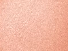 a close up view of the texture of an orange and pink leather background or wallpaper