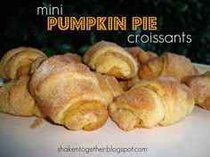 mini pumpkin pie croissants are piled on top of each other and ready to be eaten