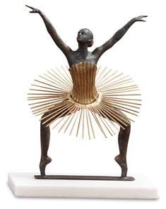 a statue of a ballerina with her arms spread out and hands in the air