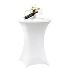 a white table topped with a bottle of wine