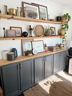 a living room filled with lots of furniture and shelves covered in pictures on top of them