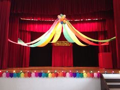 the stage is decorated with balloons and streamers