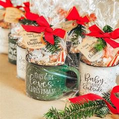 several mugs filled with christmas treats on a table