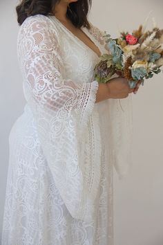 "Model size 3XL-4XL (US 18-20) Goddess boho dress with fringed bell sleeves Bridal kaftan maxi lace dress Bohemian plus size wedding dress, boho bride Vintage style wedding lace maxi dress. Made from high-quality floral lace fabric. ♥ V-neckline ♥ Depth of cleavage - 13.3'' / 34 cm ♥ Bat lace sleeve ♥ Length of sleeves front - 23.6'' / 60cm ♥ Length of sleeves back - 26.7'' / 68cm ♥ Maxi length dress ♥ Boho fringe details ♥ Lining made of high-quality viscose Lycra fabric- very comfortable ♥ Col Bridal Kaftan, Bell Sleeve Wedding Dress, Wrap Wedding Dress, Bride Vintage, Wedding Renewal, Plus Size Wedding Dress, Wedding Dress Boho, Floral Lace Fabric, Bat Sleeves