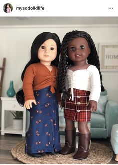 two dolls are standing next to each other