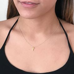 This tiny gold cross necklace is a classic addition to your layering necklaces. This minimalist necklace is also perfect by itself. - The cross charm is gold plated over sterling silver and measures approximately 12 mm in length or 1/2 inch. The dainty chain is 14k gold fill. This cross necklace is available in lengths from 14 - 20 inches. The model is wearing a 16 inch length. - Your new tiny cross necklace will come in a box, ready for gift giving. More Christian jewelry https://www.etsy.com/s Dainty Cross Necklace For Everyday Wear, Dainty Yellow Gold Cross Necklace For Everyday, Dainty Charm Necklace With Clavicle Chain And Cross Pendant, Dainty Cross Pendant Charm Necklace With Clavicle Chain, Dainty Cross Necklace With Delicate Chain For Everyday, Dainty Everyday Cross Necklace With Delicate Chain, Dainty Charm Necklace With Cross Pendant And Adjustable Chain, Dainty Cross Necklace With Delicate Chain, Delicate Everyday Cross Necklace