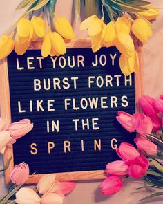 a sign that says let your joy burst forth like flowers in the spring with pink and yellow tulips