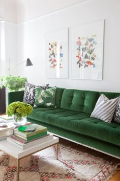 a living room filled with green couches and pillows