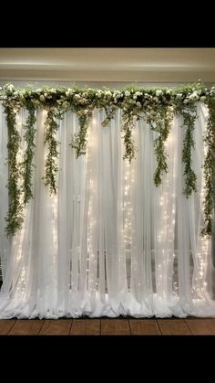 the curtain is covered with greenery and lights