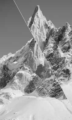 a black and white photo of mountains with skis in the foreground, taken from below