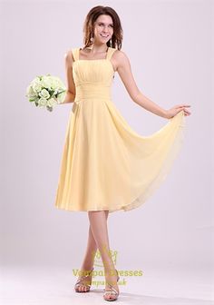 a woman in a yellow dress posing for the camera with her hand on her hip