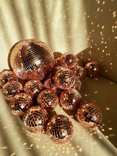 many shiny disco balls sitting on top of a table