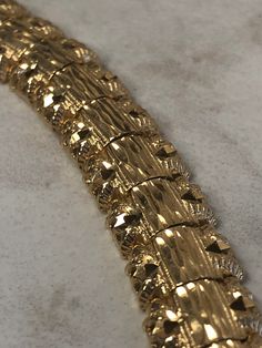 "14kt Yellow Gold Lady's Solid Bracelet 7\" in length that has a wide mirror nugget diamond cut pattern with a bright shiny polished look that each section is hinged for maximum flexibility and comfortable wear. The 3/8\" wide bracelet has a hidden box clasp with a fig 8 secure safety clasp. This bracelet weighs 18.5 grams. This item would Retail for $2,759.00" Gold Bracelet With Shiny Finish For Anniversary, Gold Diamond Cut Bracelet For Anniversary, Wide Mirror, Wide Bracelet, Box Clasp, Gold Hoop, Mens Wedding Bands, Gold Hoop Earrings, Wedding Men