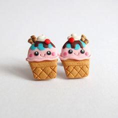 two small ice cream cones with toppings on them are sitting next to each other