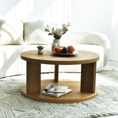 a coffee table with fruit and flowers on it