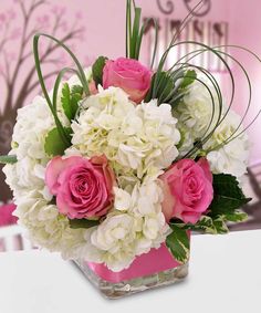 a vase filled with pink and white flowers