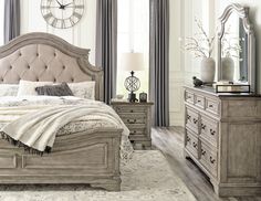 a bedroom scene with focus on the bed and dresser