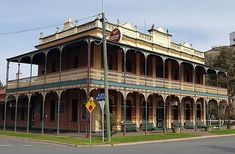 an old fashioned building on the corner of a street