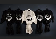 three robes hanging on a wall with the names of brides and grooms written on them