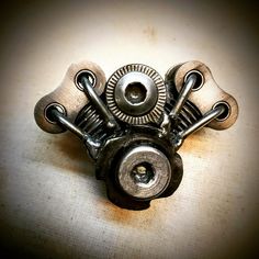 an old metal object sitting on top of a table